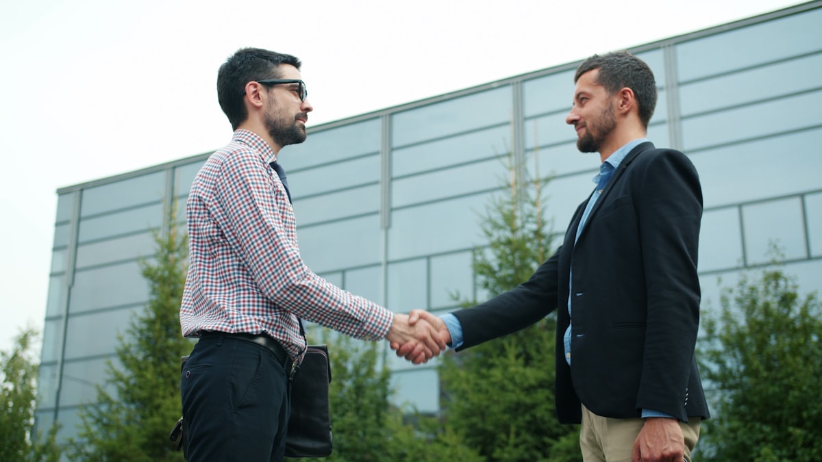 Business partners shaking hands after agreeing on a service plan